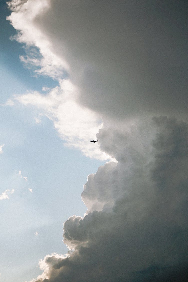 White Cloud Over Flying Airplane