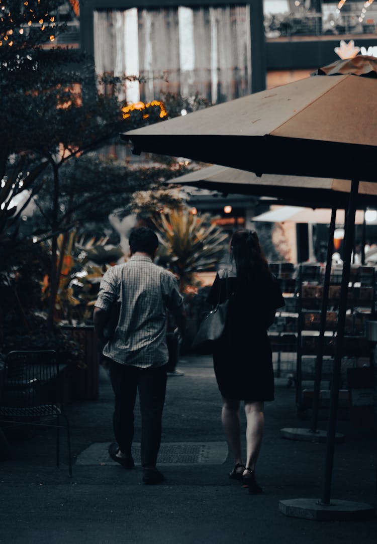 Couple Walking Down The Sidewalk To A Restaurant