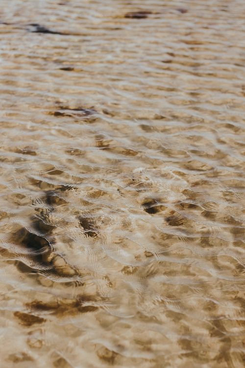 Free Close-up of rippling shallow water capturing wave patterns at Aracati Beach, Brazil. Stock Photo