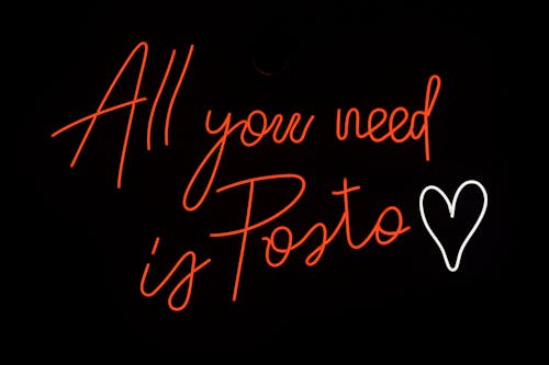 A Red Neon Sign Saying "All You Need is Pasta" 