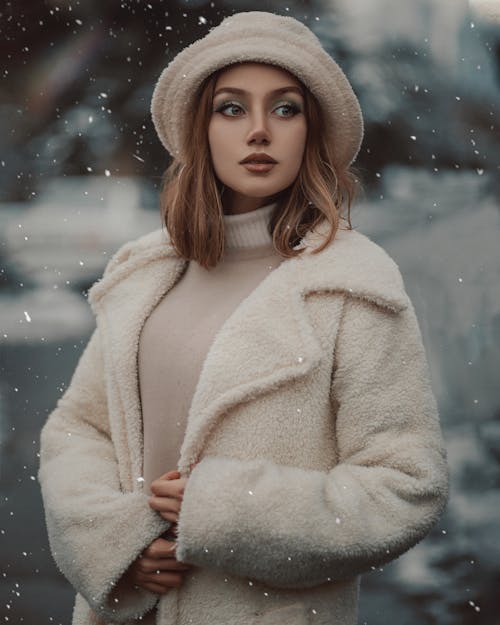 Young Woman in a Warm Winter Coat Standing Outside 