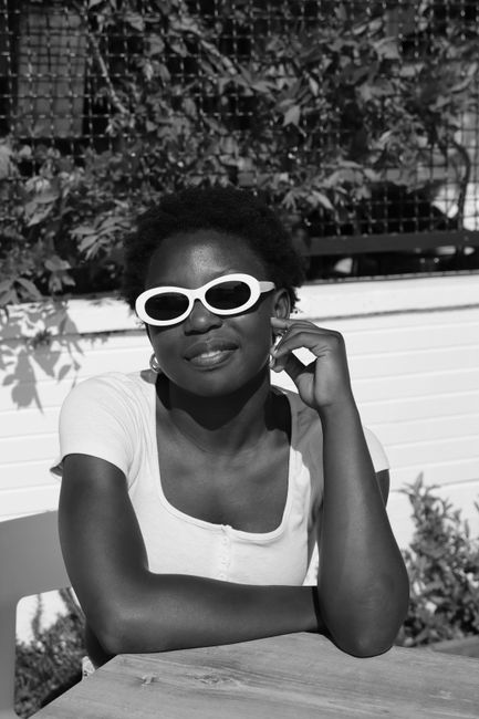 Chic woman in sunglasses enjoys a sunny day in Venice, Italy, showcasing leisure and fashion.