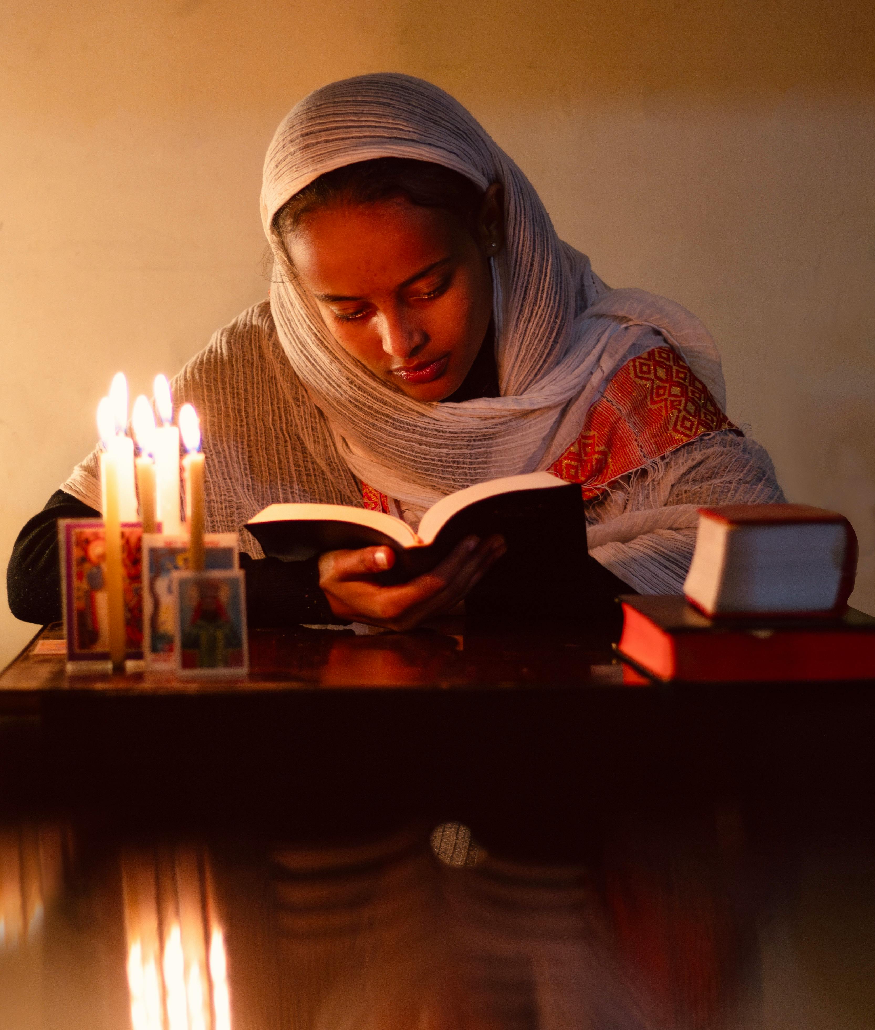 woman-in-white-robes-and-with-candle