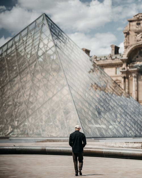 Man Walking towards Louvre Pyramid