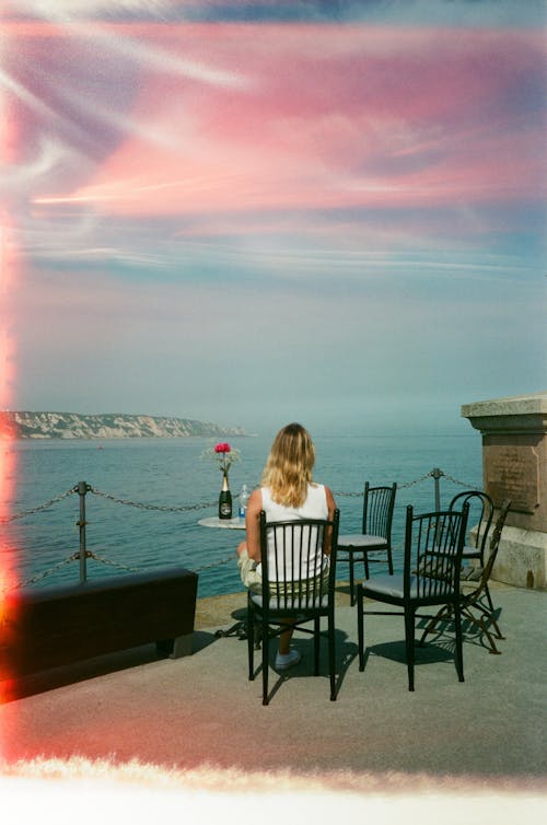 Woman Sitting on Terrace on Sea Shore