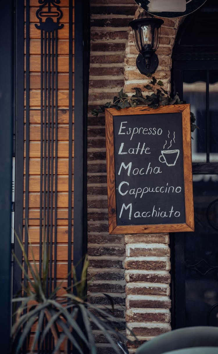 A Chalkboard Sign On The Outside Of A Cafe 