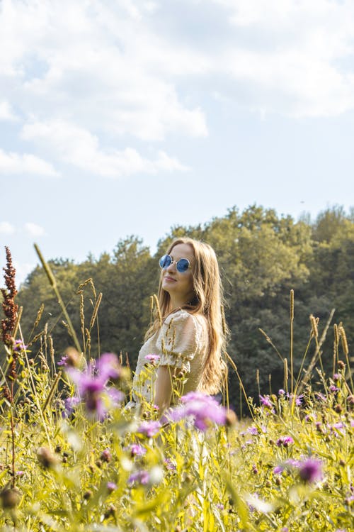 Young Woman Posing on the Meadow in Summer 