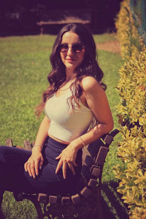 Brunette Woman in Sunglasses Sitting on Bench