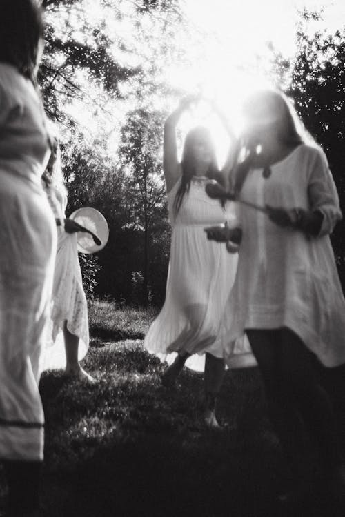 Women in White Clothes Playing at Sunset