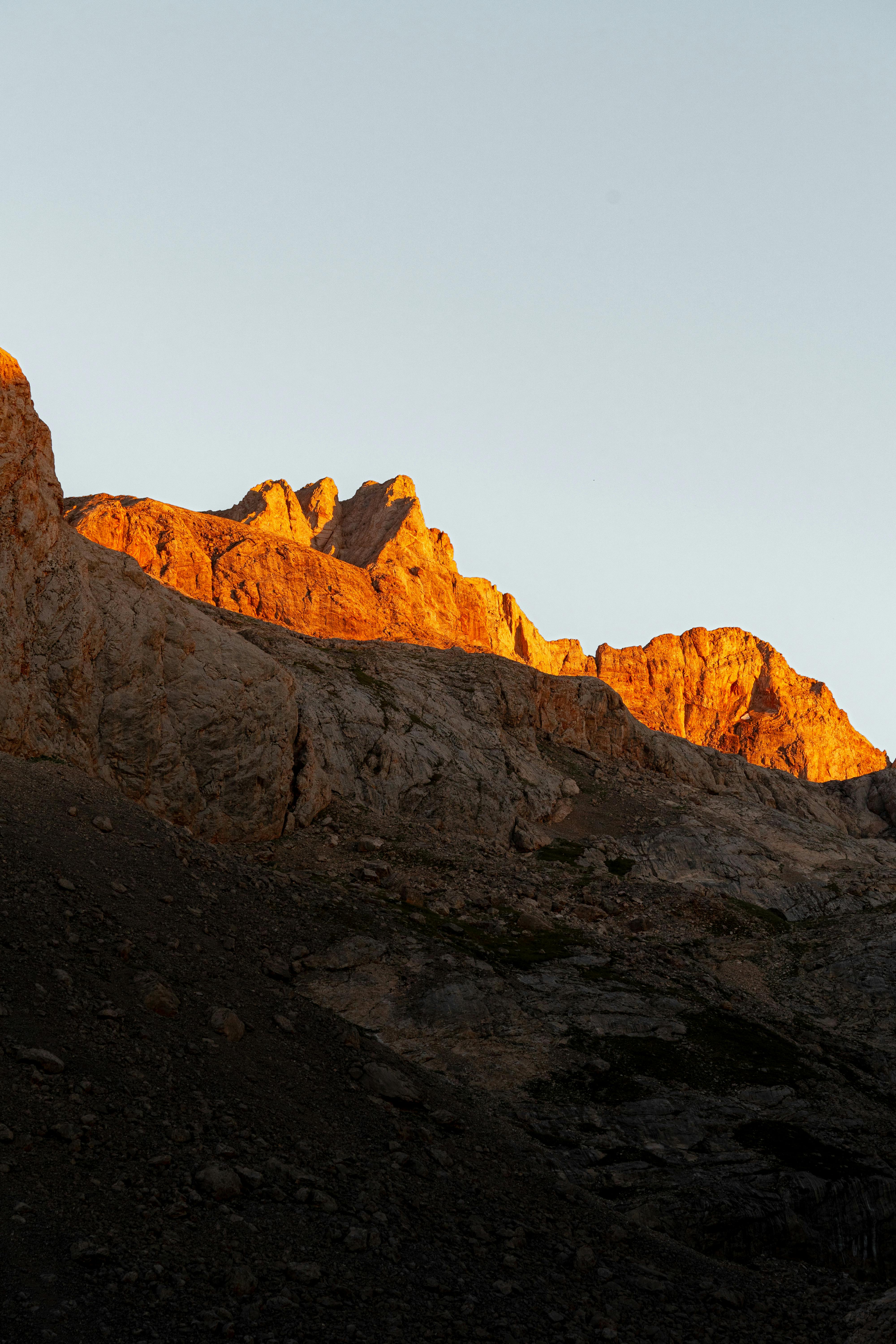 Sunlight casts a warm glow on the rugged mountain peaks in İzmir, Turkey.