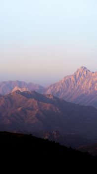 Stunning aerial view of Turkey's mountains with soft dawn light casting shadows over the peaks.