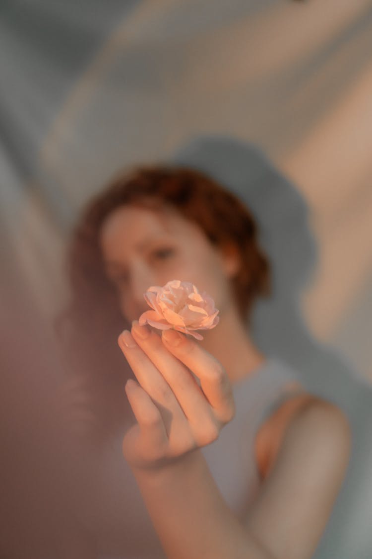 Woman Holding Flower In Blur