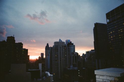 Free Captivating cityscape with skyscrapers silhouetted against a colorful evening sky. Stock Photo
