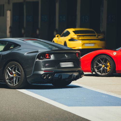 Free Three high-performance cars at a racing circuit in Noida, UP, India. Stock Photo