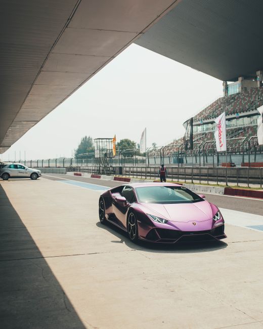Striking purple Lamborghini on an empty race track in Noida, India.