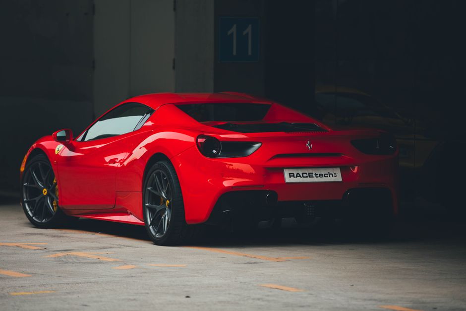 High-performance red Ferrari 488 GTB showcased on a race track, highlighting its elegant design.