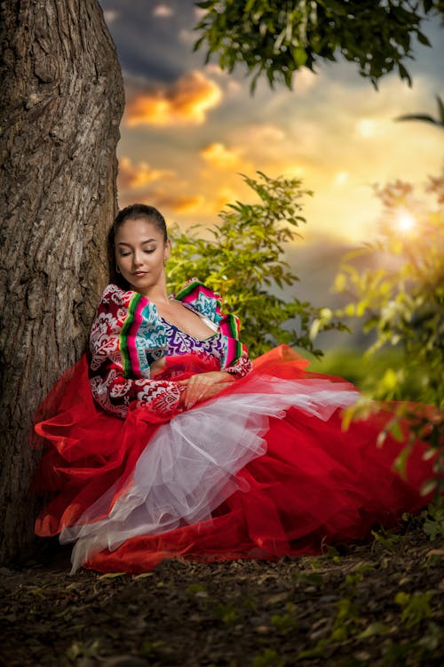 Brunette Woman in Peruvian Dress Sitting by Tree