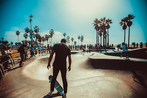 Man Standing on Skateboard Near Skate Park