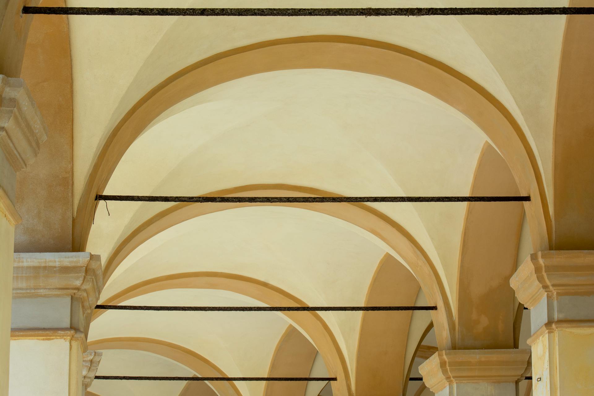 Capture of the iconic arched walkways in Bologna, Italy, showcasing architectural elegance.