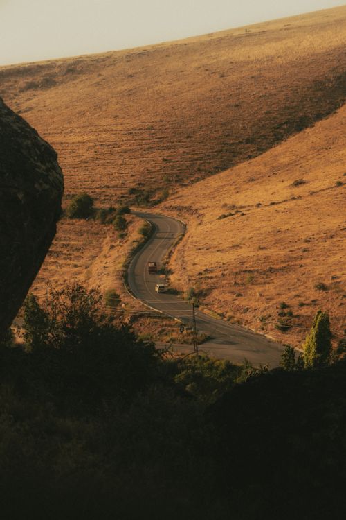 Free A picturesque view of a curving road through the golden hills of İncesu, Kayseri, Türkiye. Stock Photo