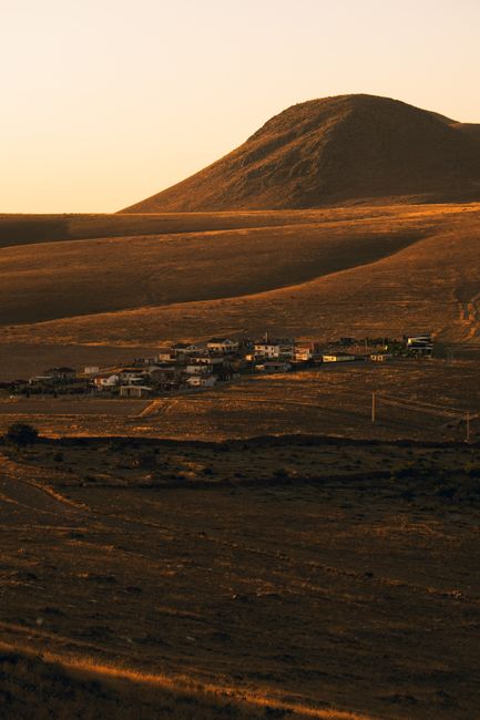 Scenic view of İncesu in Kayseri during sunset, with a small village in the foreground.