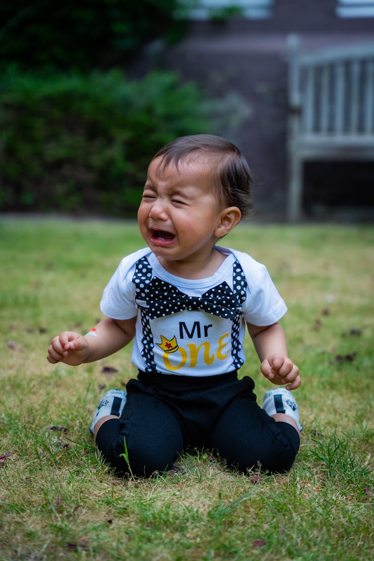 Crying Boy On Grass