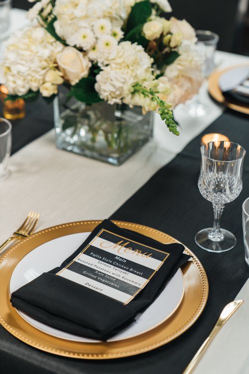 Free Chic table setup with floral centerpiece and elegant dinnerware in Fort Lauderdale, FL. Stock Photo