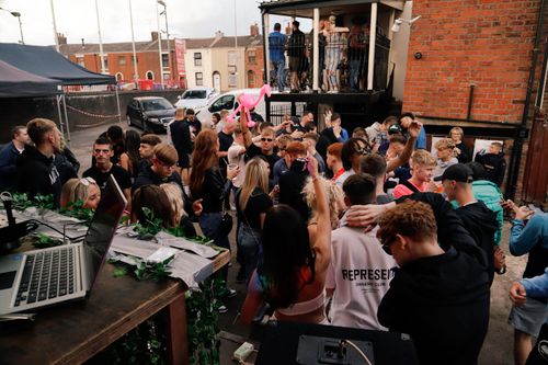 Free Energetic outdoor party scene with people dancing and socializing, perfect for event promotions. Stock Photo