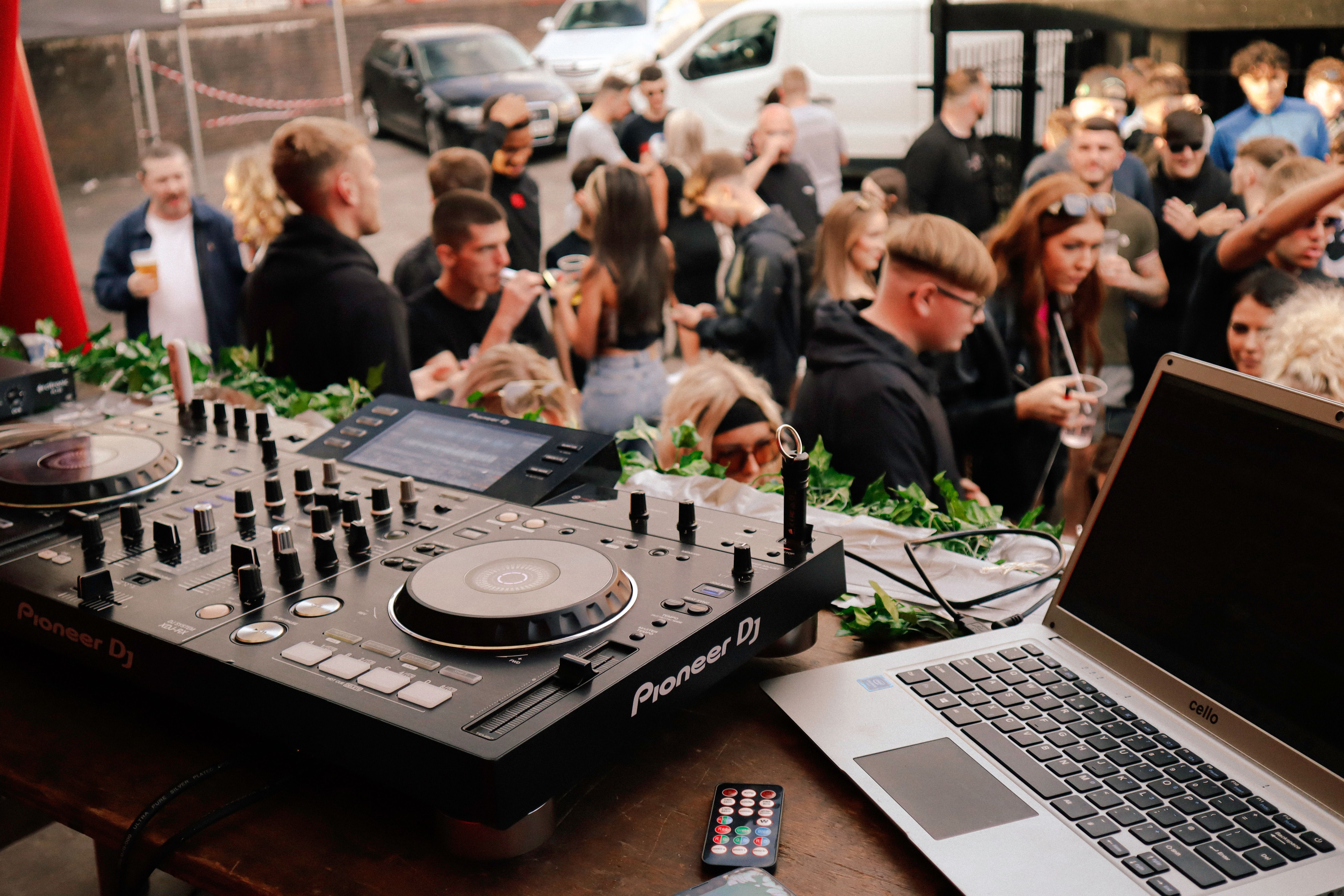 A Laptop and a DJ Console on the Stage · Free Stock Photo