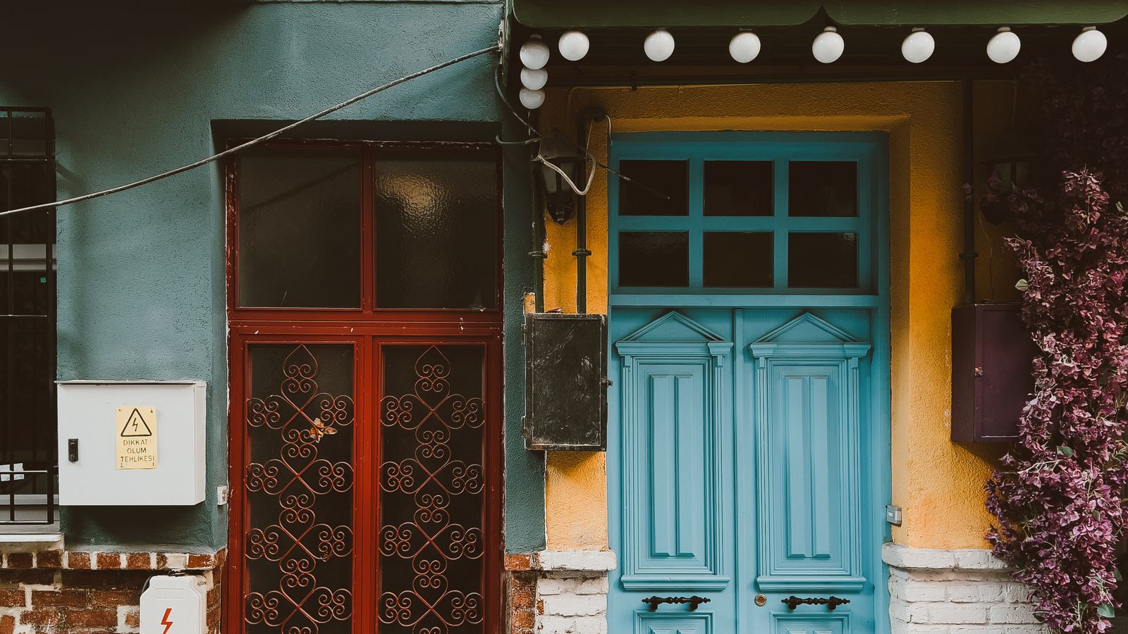 Adjoining homes with red and blue front doors