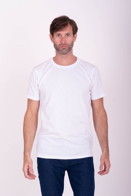 Man in a plain white t-shirt and jeans in a studio — photo by Estefania Milazzo on Pexels