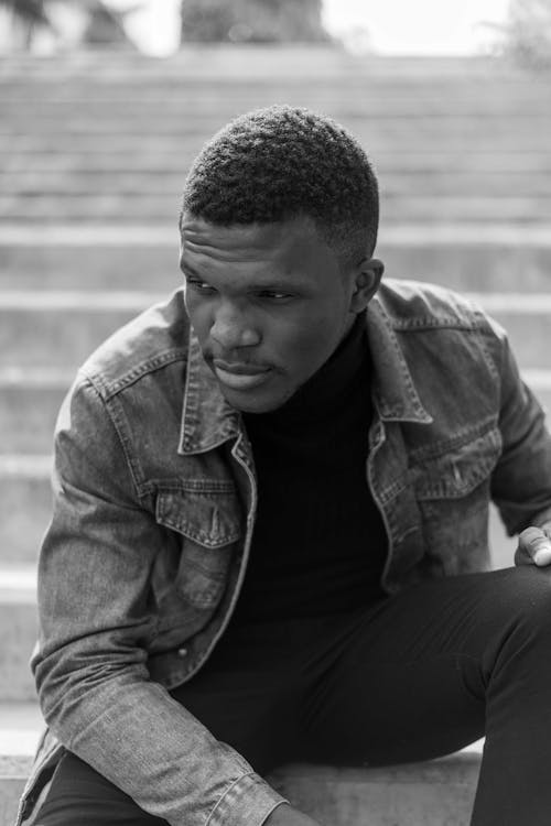 Model in Denim Jacket Sitting on Stairs