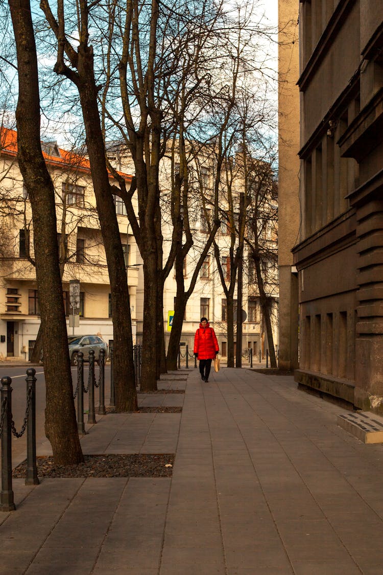 Woman In Red Jacket On Sidewalk