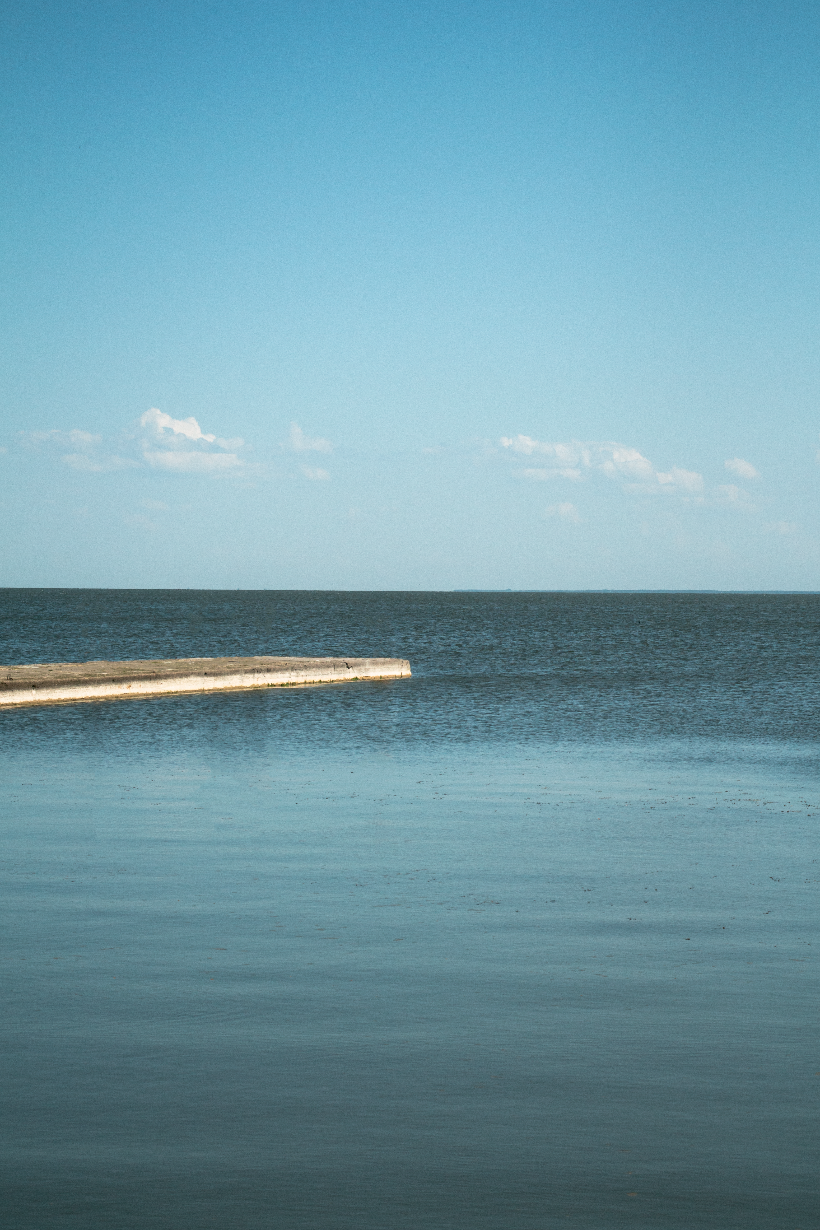 View of a Calm Sea under Clear Blue Sky · Free Stock Photo