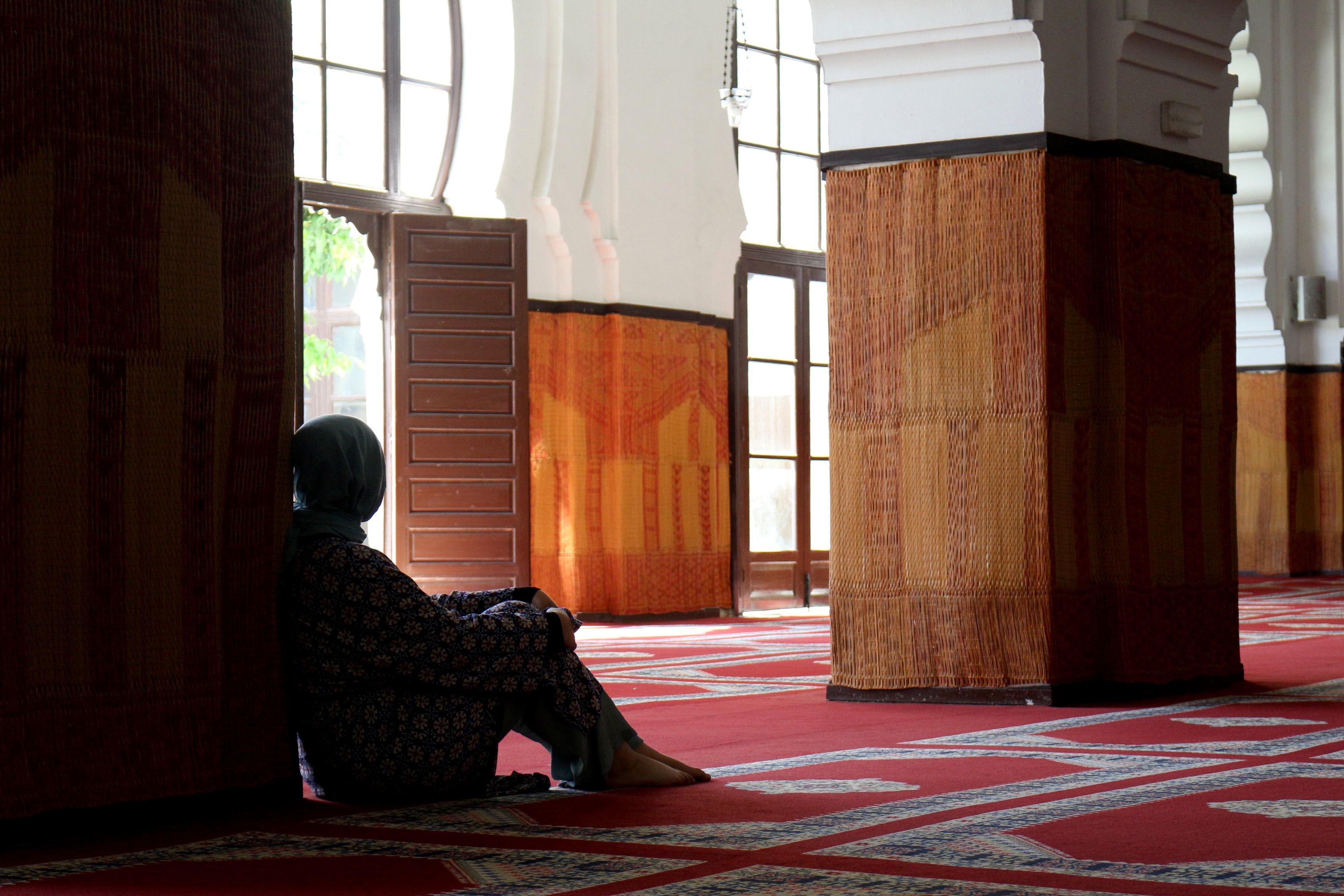 Woman Sitting at a Pillar in the Mosque Looking Towards the Exit · Free ...
