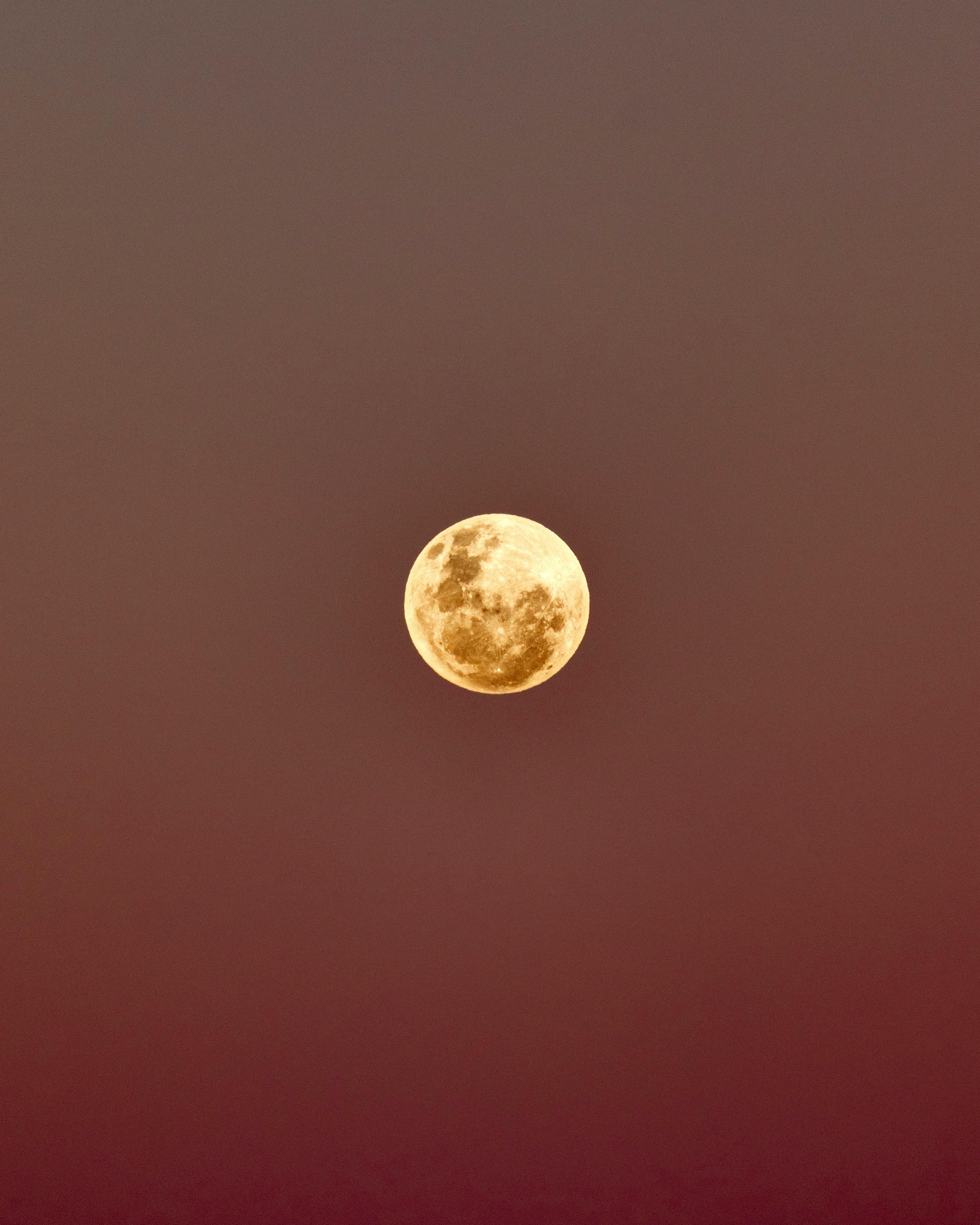 A captivating view of the full moon against a dusk sky in Rio de Janeiro.