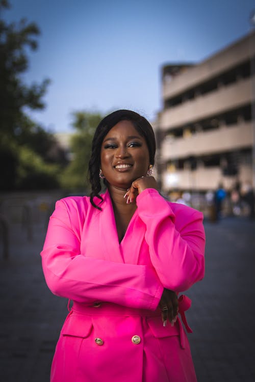 Smiling Woman in Pink Suit