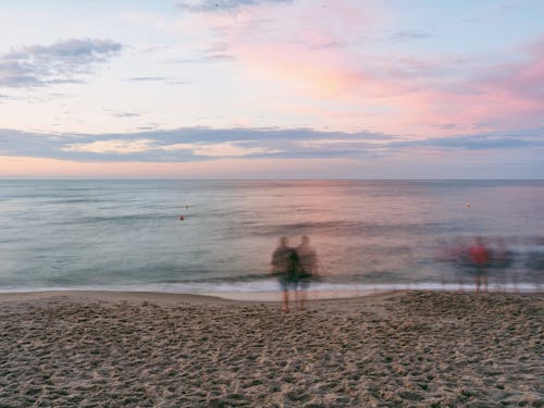 Blurred Motion of People on Sandy Beach