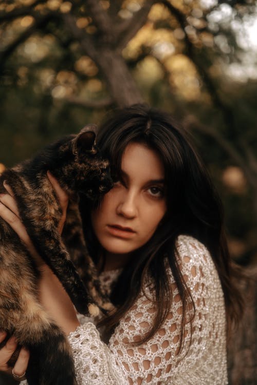 Woman in Lace Clothes Holding Cat