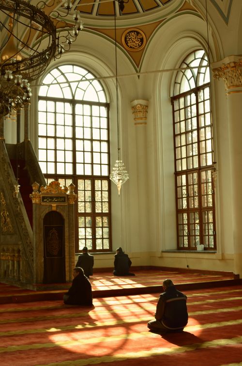 Free Serene moment of meditation inside a beautifully sunlit mosque. Spiritual ambiance. Stock Photo