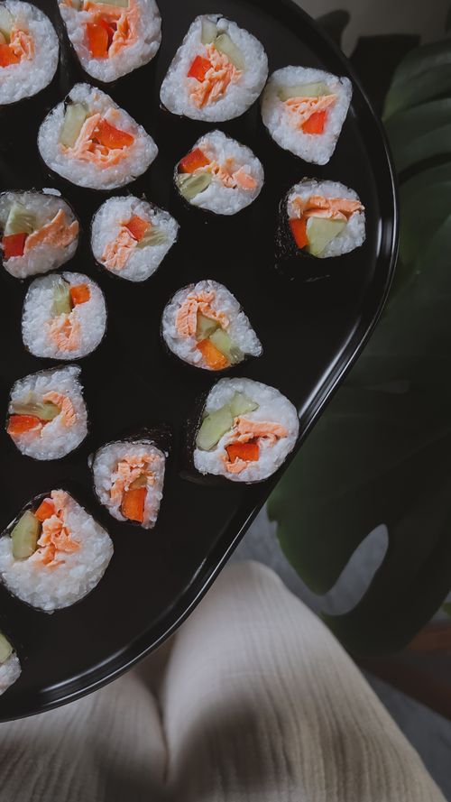 Free Colorful sushi rolls with vegetables and seafood on a black plate, top view. Stock Photo