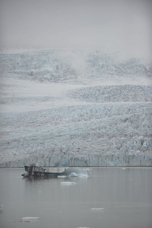 Free Frozen glacier and icebergs reflecting in cold, calm water at polar region. Stock Photo
