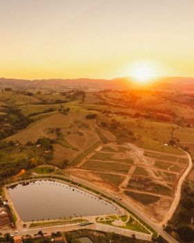 Beautiful aerial image capturing a scenic sunrise over a park reservoir and surrounding landscape.