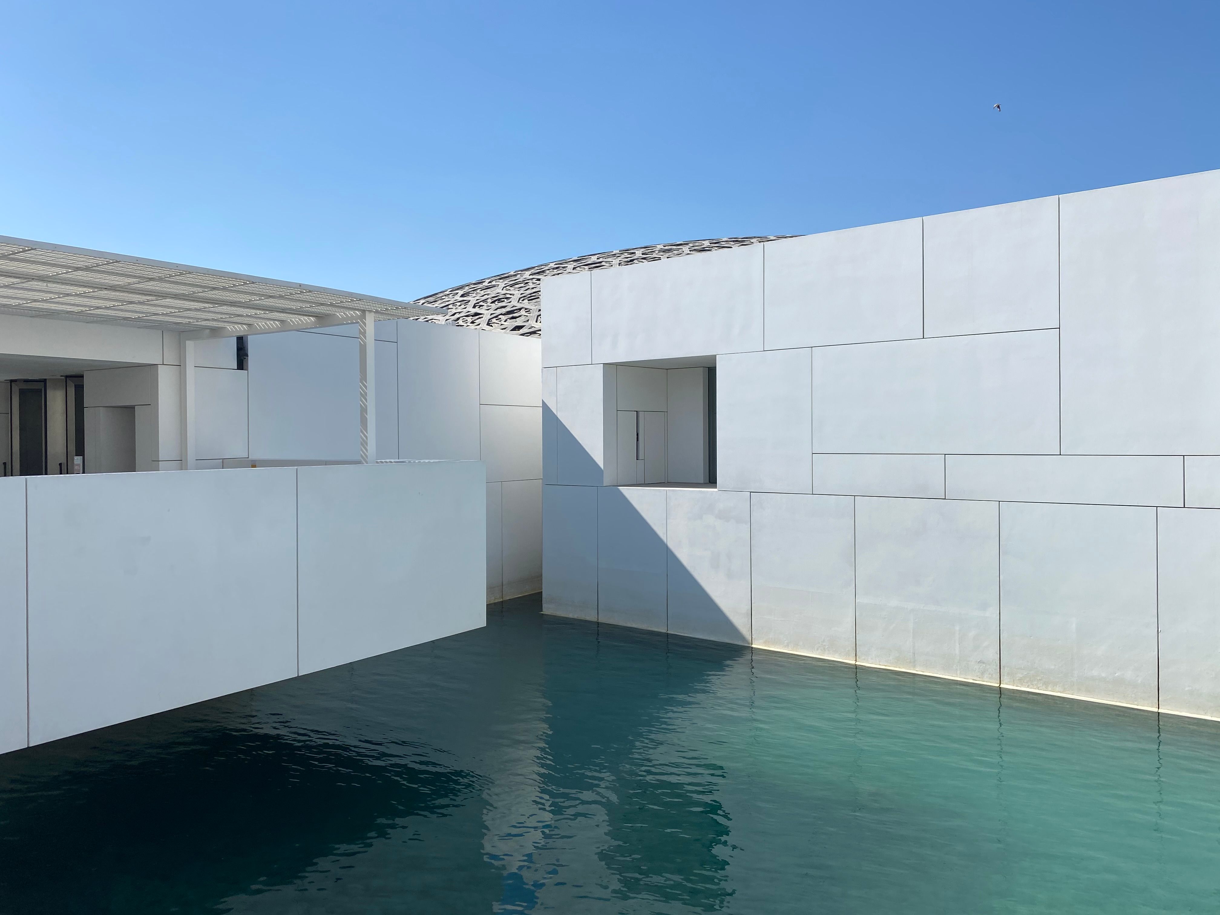 Minimalist resort architecture with pool, stone, and serene lighting