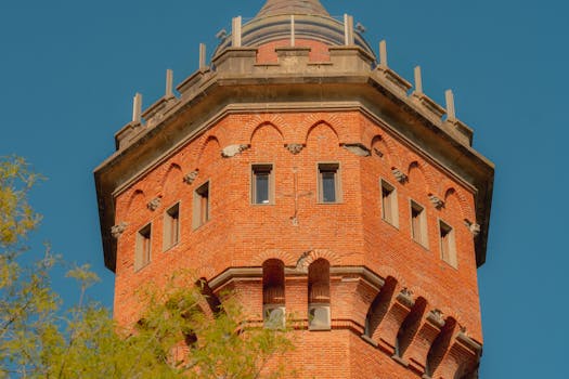 A striking view of a historic brick water tower under a clear blue sky in Uruguayana, Brazil.
