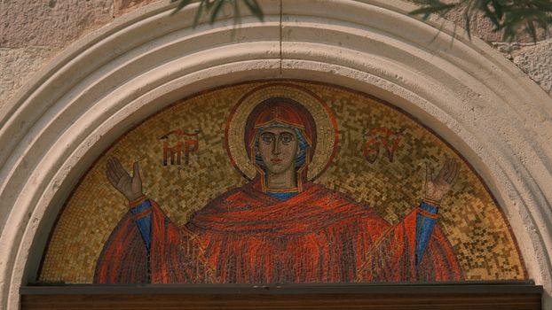 A detailed mosaic of the Virgin Mary at a church entrance, reflecting Christian art.