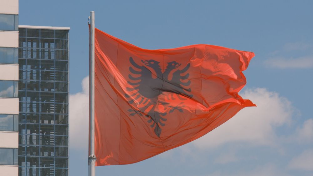 Flag of Albania waving over Tirana