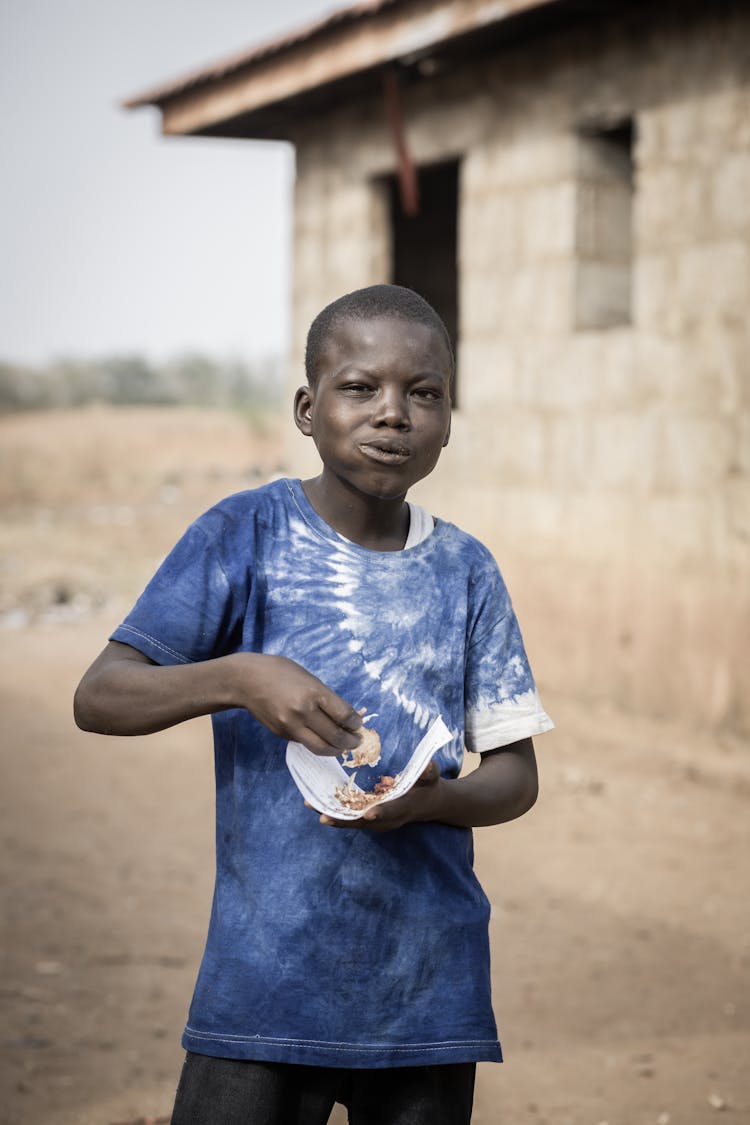 Boy Eating On Street