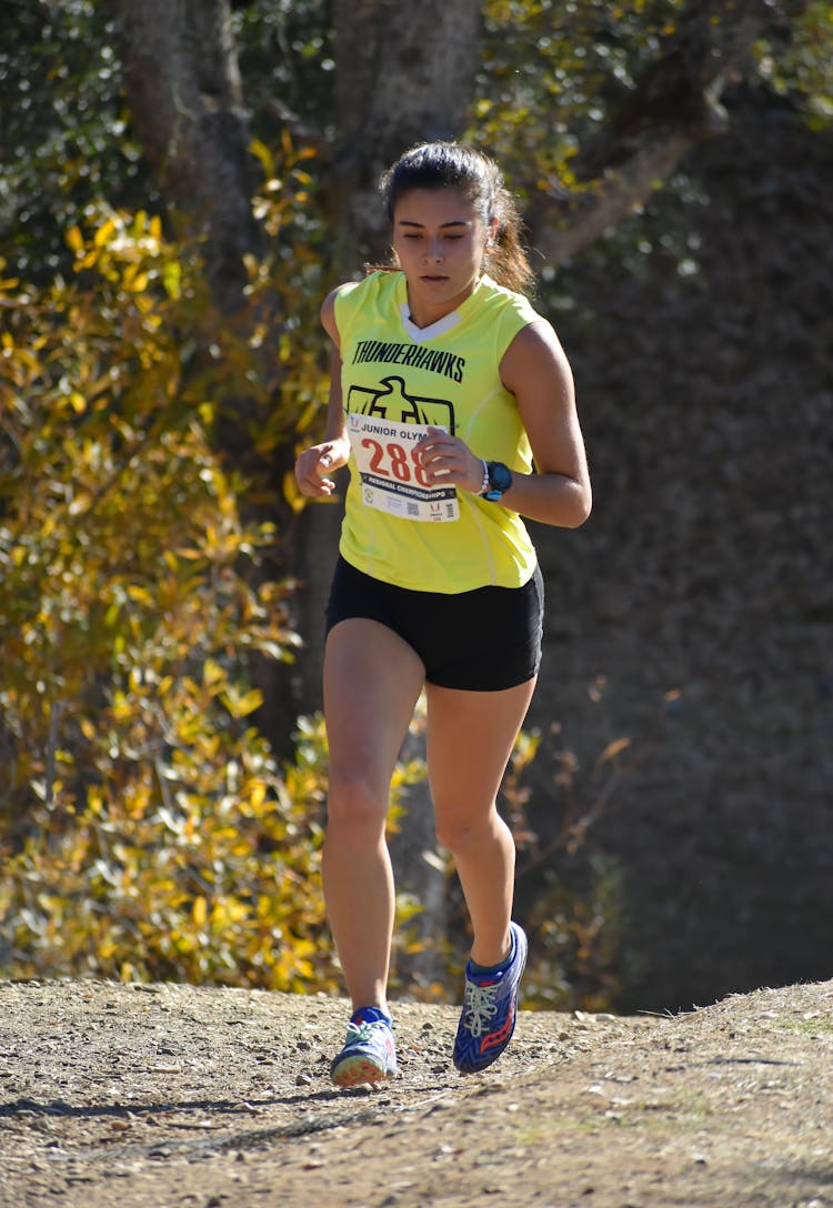 Woman Running In Cross-Country Race