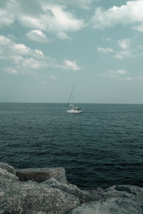 A sailboat is sailing on the ocean